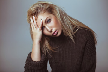 Contemplative woman in sweater