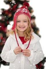 Composite image of festive little girl in hat and scarf