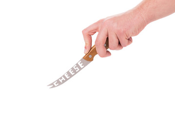 Hand holds cheese knife.