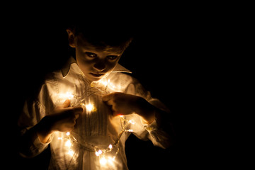 boy portrait whit christmas lights