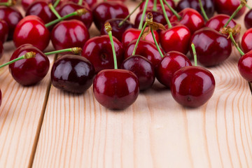Fresh cherries on wooden table in the closeup.