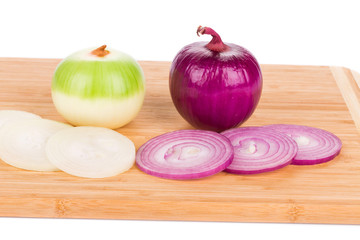Rings cut spanish onions on wood board.