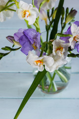 Naklejka na ściany i meble fresh spring daffodil in glass on table