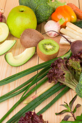 Vegetables on a wooden table in the closeup.