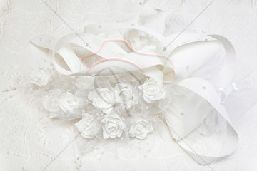 Wedding gown and decorated with white roses.