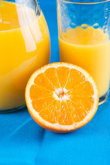 Fresh oragnic orange juice with fruit halves