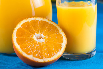 Orange juice in jar and glas with fruit slice