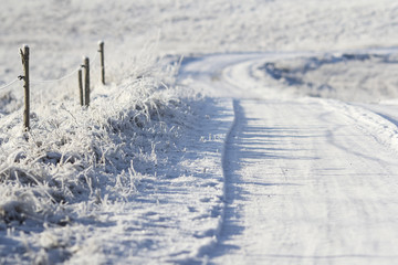snowy winter road at sunrise
