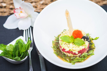 Elegant salad Tartar with herring, avocado, lettuce, restaurant