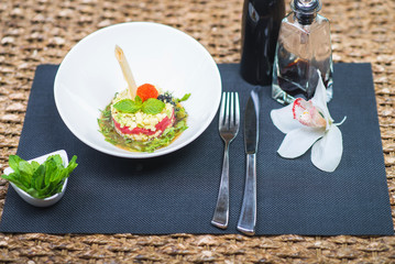 Elegant salad Tartar with herring, avocado, lettuce, restaurant