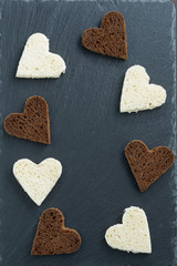 Fototapeta premium dark background with toasted rye and white bread in heart shape