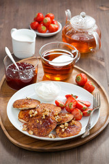 Delicious breakfast. Pancakes with fresh strawberries and cream
