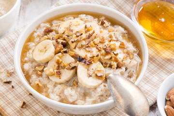 healthy breakfast - oatmeal with banana, honey and walnuts