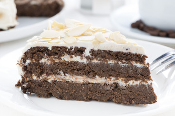 piece of chocolate cake with butter cream, close-up
