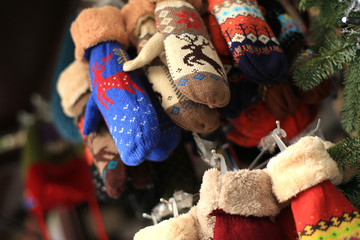 Colorful patterned woolen mittens in the shop on the street