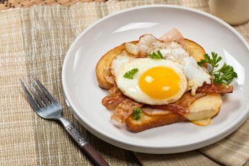 Sandwich with fried eggs - Croque Madame. Selective focus.