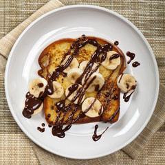French Toast with Bananas and Chocolate sauce. Selective focus
