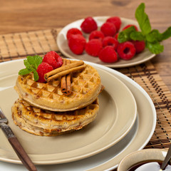 Waffles with raspberries and cinnamon. Selective focus.