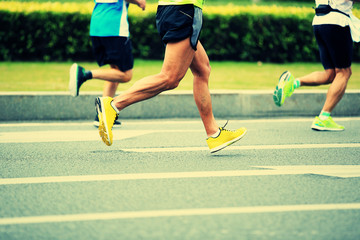 marathon runner legs running on city street
