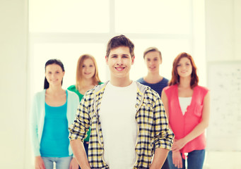 Fototapeta premium smiling male student with group of classmates