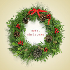 Fototapeta na wymiar text merry christmas and natural christmas wreath, with a retro