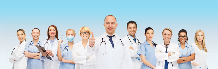 group of smiling doctors with showing thumbs up