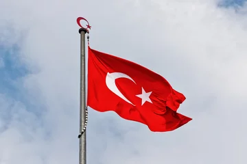 Poster Turkish flag waving in blue sky © stefanholm