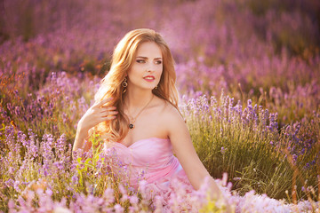 Sensual Woman Lying on a Meadow with Violet Flowers.