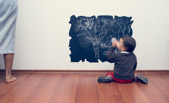 Little Girl Drawing On The Wall