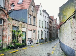 Medieval empty side street of Bruges, Belgium, with a bike parke