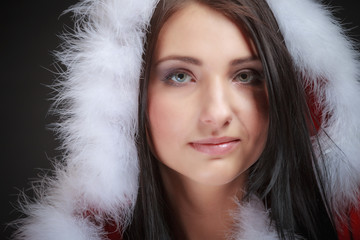 Portrait woman wearing santa clause costume on black