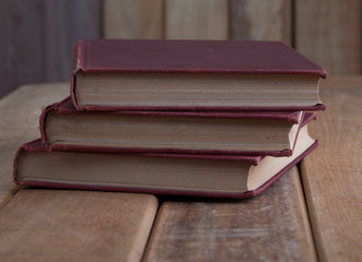 Three Vintage Books on Rustic wooden table