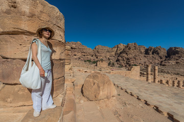 tourist standing roman temple in Nabatean city of  Petra Jordan