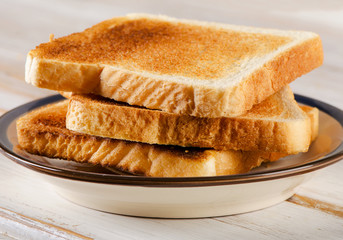 Three Slices toast bread on a wooden background .