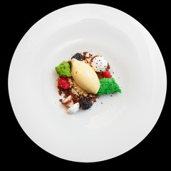 Elegant dessert in plate isolated on black