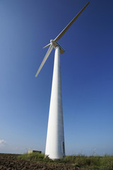 Fototapeta na wymiar Photo of Wind power installation in sunny day