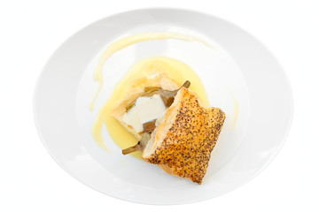 Bun with braised artichoke on oval plate isolated on white