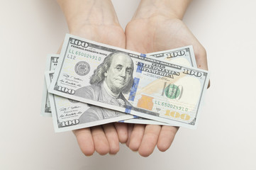 $ 100 bills that have been placed in the hands