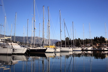 sail Boats and yachts reflected in calm marina