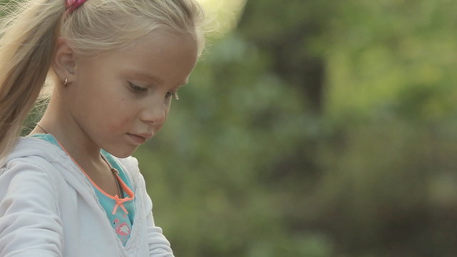 Little girl resting with his family in the forest and inflates