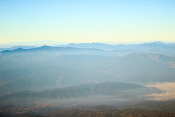 Fototapeta na wymiar Nature on mountain peaks with mist overlay