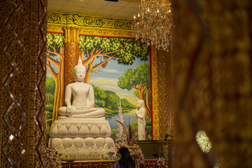 white stone Buddha sculpture in thailand temple