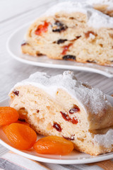 A piece of cake with raisins, dried apricots closeup. vertical