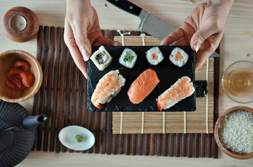 hands cooking sushi