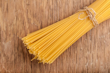 sheaf raw pasta tied with a rope