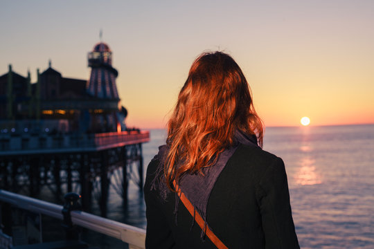 Woman admiring the sea at sunset