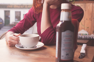 Woman having coffee in cafe