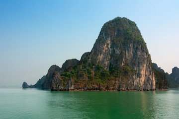 Halong Bay Vietnam with tourist boats and hazy blue sky
