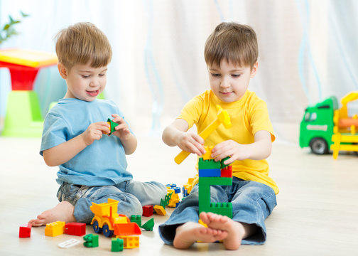 Kids playing toys in playroom at nursery