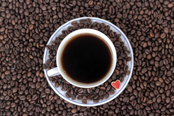 cup of coffee with heart on the background of coffee